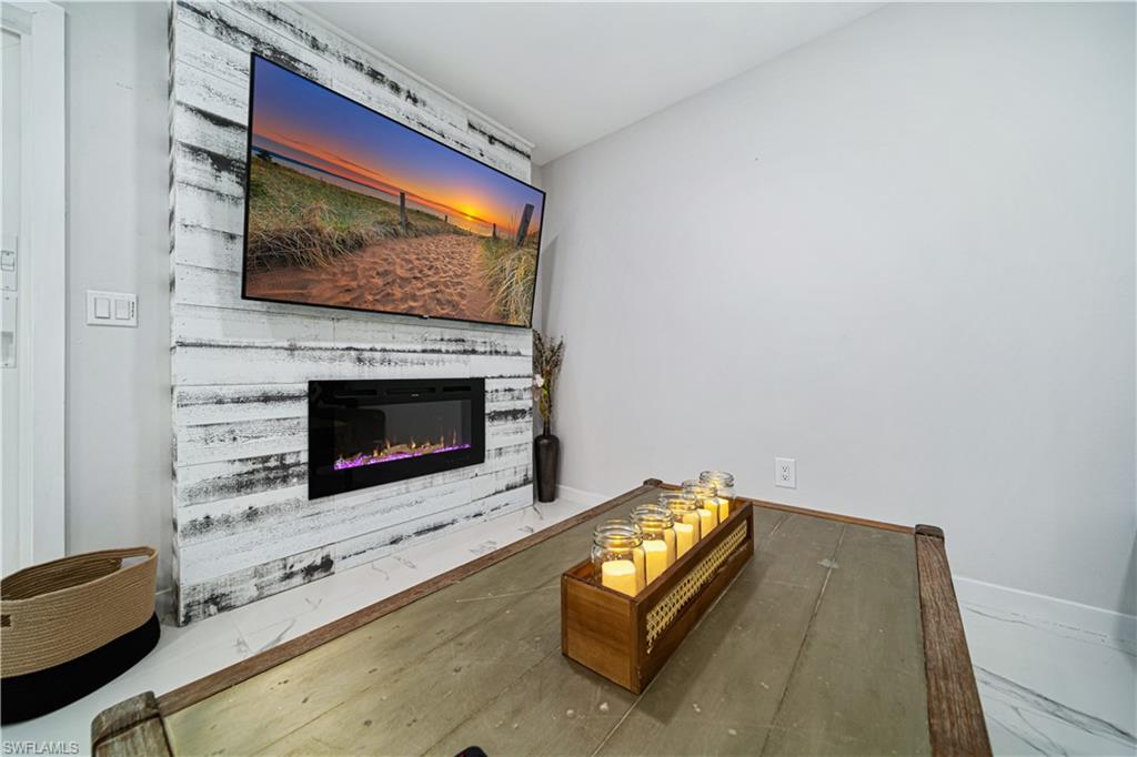 4439 Parrot Avenue Naples, FL 34104 - Photo 5 of 39 a living room with furniture fireplace and flat screen tv