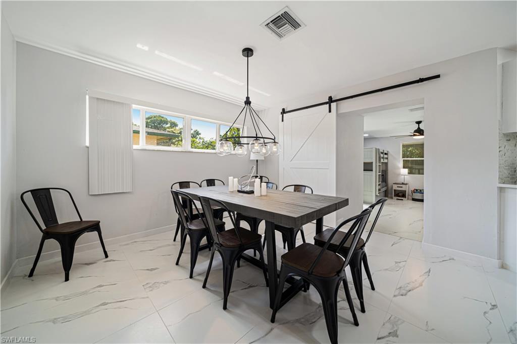 4439 Parrot Avenue Naples, FL 34104 - Photo 9 of 39 a view of a dining room with furniture