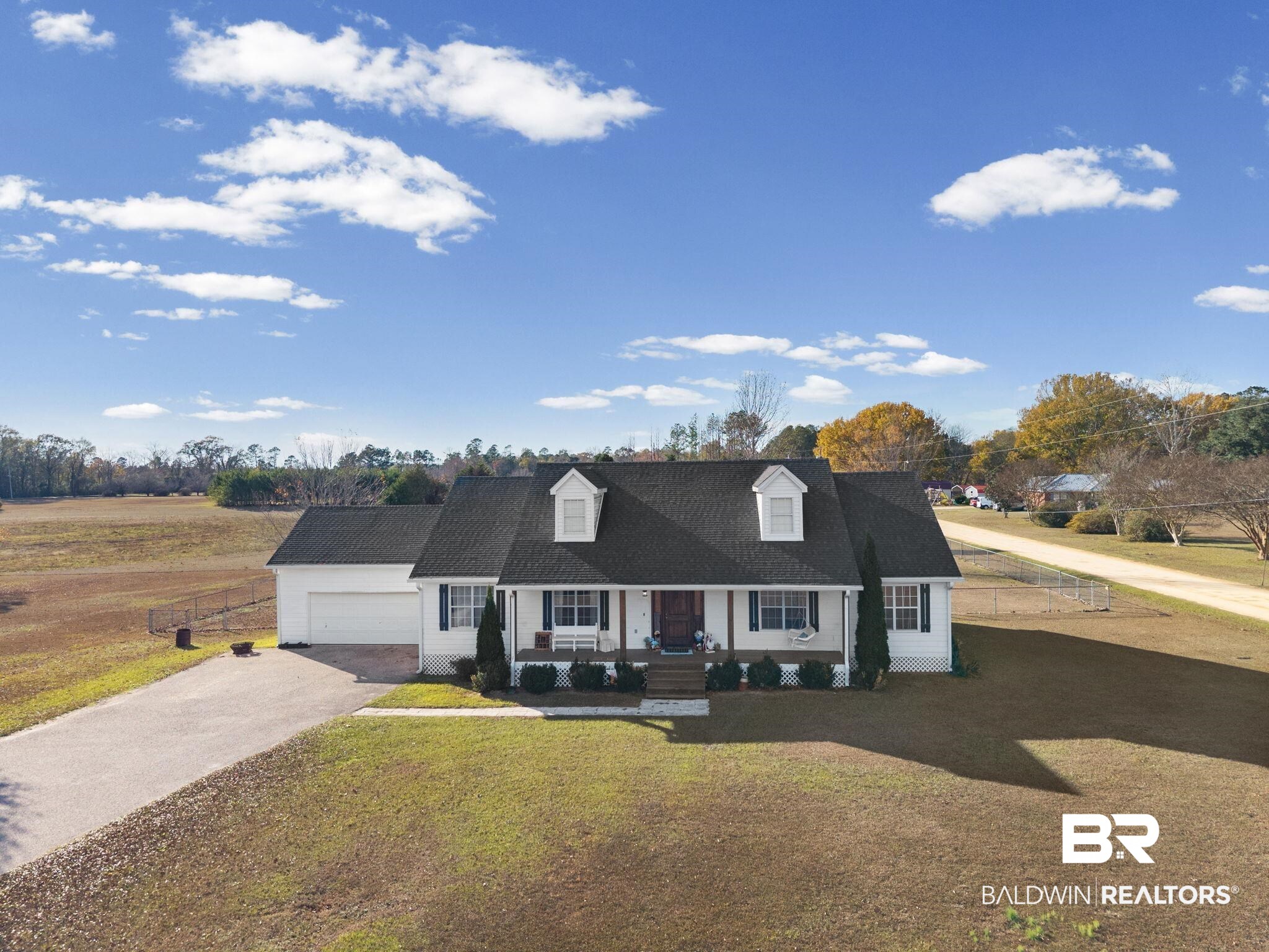 3842 Experiment Farm Road Monroeville, AL 36460 - Photo 54 of 59 Cape cod house featuring a porch, asphalt driveway, and a front lawn