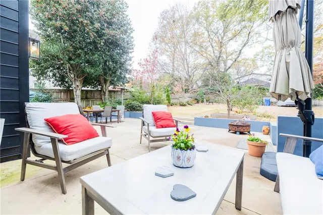 a view of a patio with table and chairs and potted plants