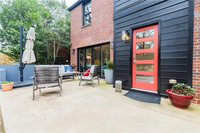 a view of a livingroom with wooden floor and a flat screen tv
