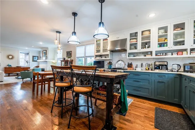 a view of a hallway with wooden floor and stairs
