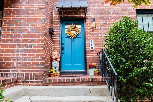 a building outdoor space with patio furniture and potted plants