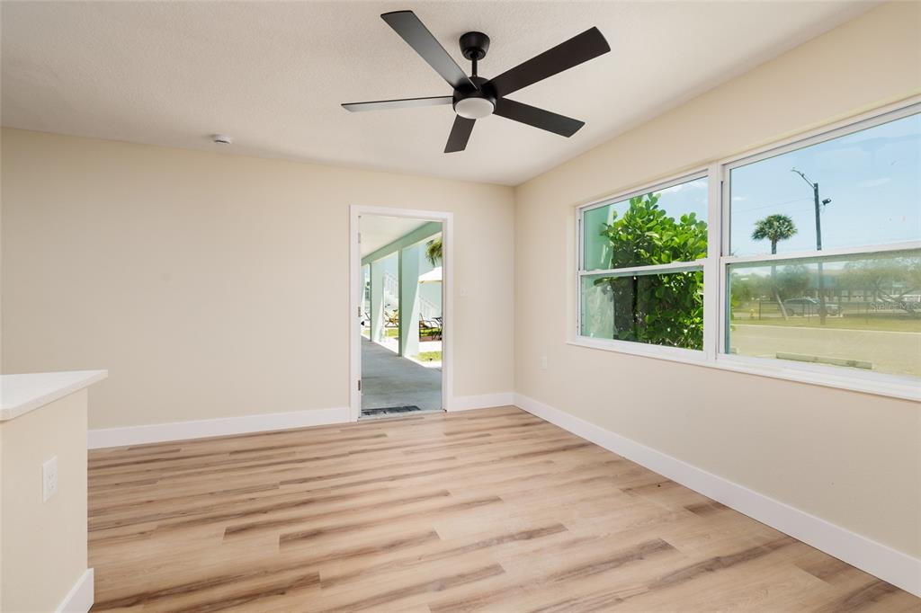 10 164th Avenue, Unit 1 Redington Beach, FL 33708 - Photo 12 of 38 a view of empty room with wooden floor and fan