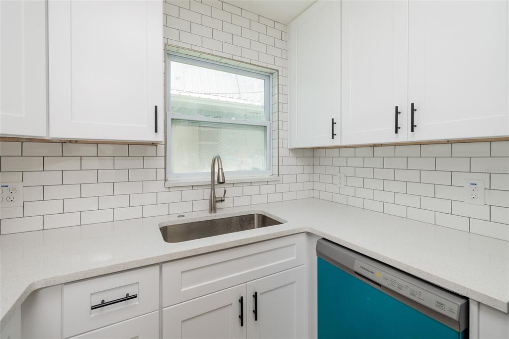 10 164th Avenue, Unit 1 Redington Beach, FL 33708 - Photo 17 of 38 a kitchen with a sink and cabinets
