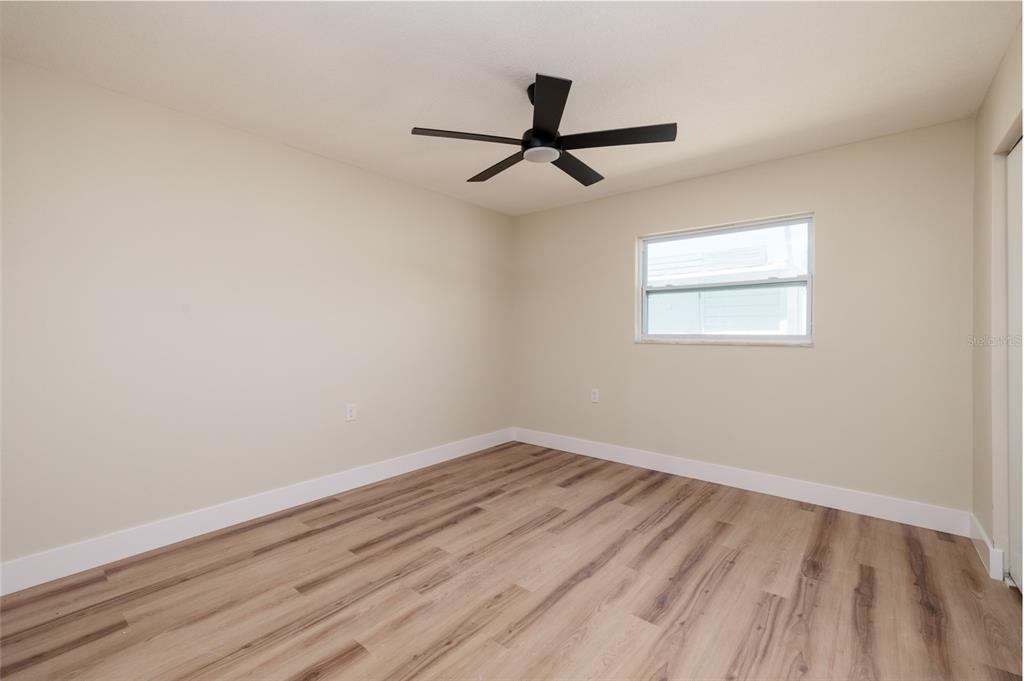 10 164th Avenue, Unit 1 Redington Beach, FL 33708 - Photo 18 of 38 wooden floor in an empty room