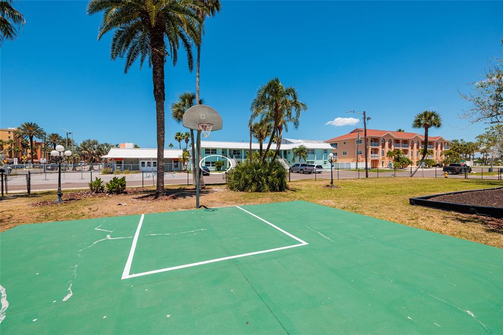 10 164th Avenue, Unit 1 Redington Beach, FL 33708 - Photo 25 of 38 a view of a swimming pool with a garden