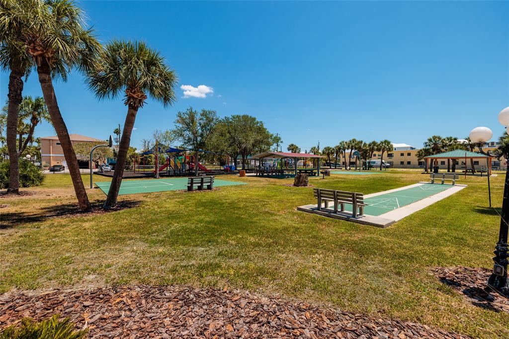 10 164th Avenue, Unit 1 Redington Beach, FL 33708 - Photo 26 of 38 a view of a swimming pool with an outdoor space and seating area