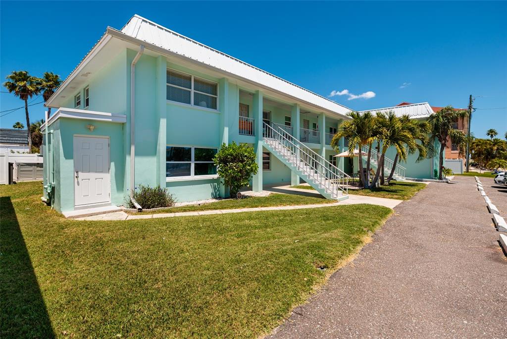 10 164th Avenue, Unit 1 Redington Beach, FL 33708 - Photo 9 of 38 a view of a house with backyard and tree