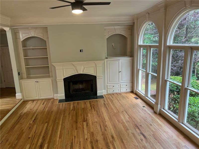 2728 Chieftain Run Duluth, GA 30097 - Photo 4 of 17 an empty room with wooden floor a fireplace and windows