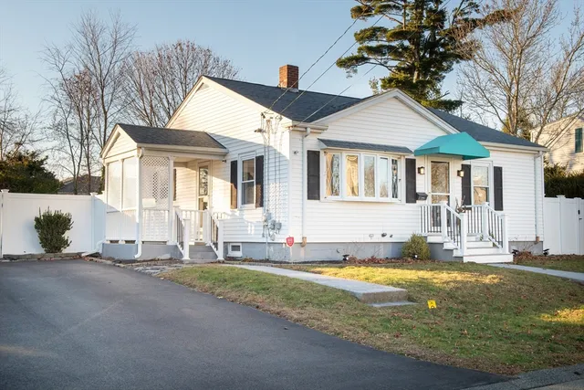 a front view of a house with swimming pool and sitting area