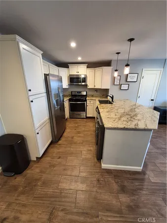 a view of kitchen with refrigerator microwave and cabinets
