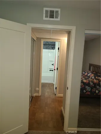 a bed sitting in a bedroom next to a window