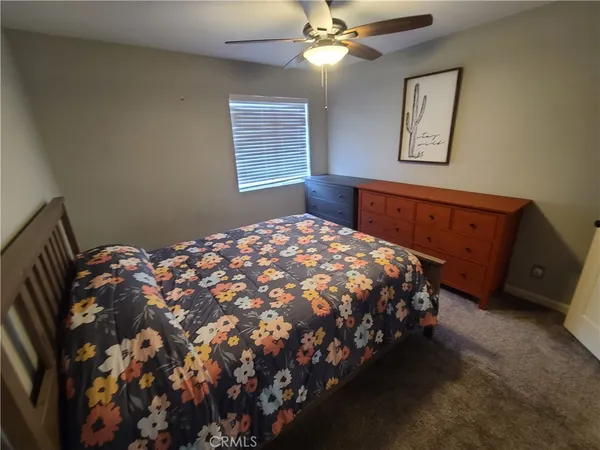 a bed sitting in a bedroom next to a larger window