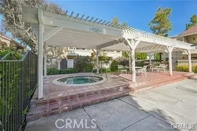 a view of house with outdoor seating area and trees