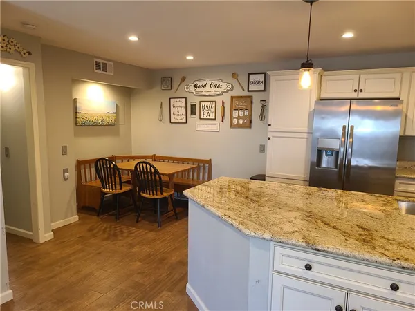a kitchen with stainless steel appliances granite countertop sink and refrigerator