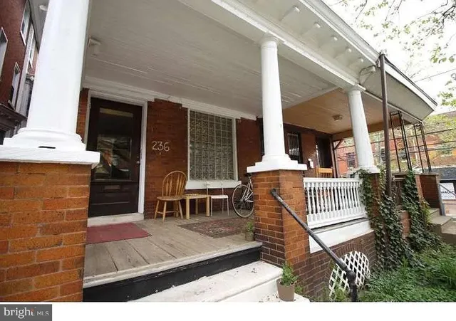 a view of a patio with table and chairs with wooden floor and fence
