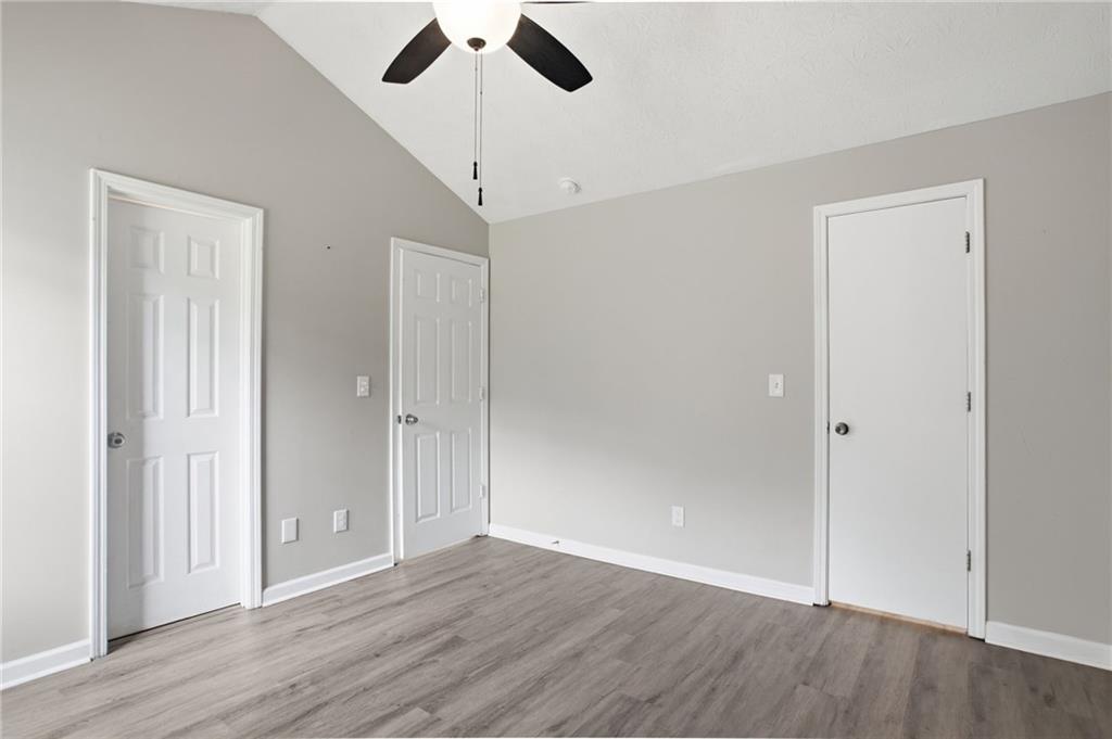 5855 Crescent Ridge Court Lithonia, GA 30058 - Photo 22 of 46 an empty room with wooden floor and windows