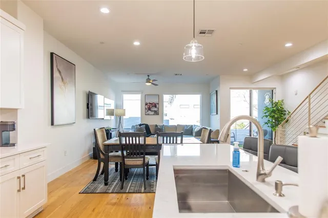 a bedroom with a large bed and a flat tv screen on dresser
