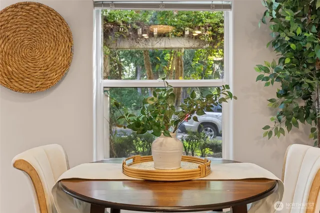 a dining room with a glass table and chairs
