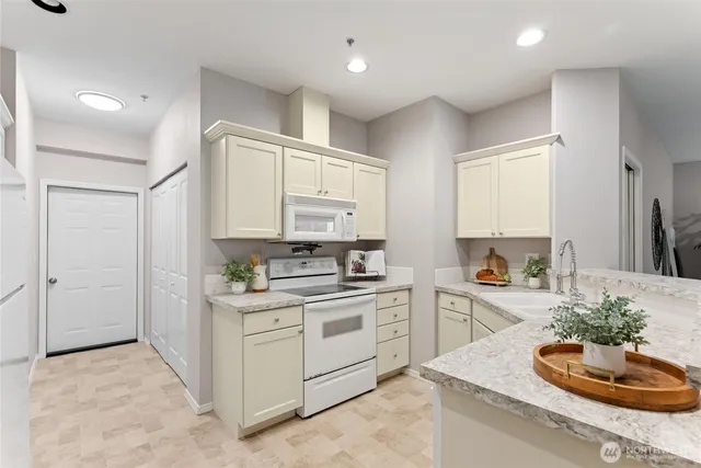 a kitchen with a sink stove and cabinets