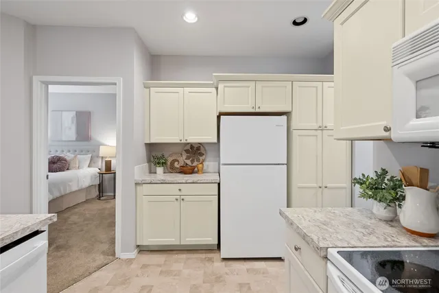 a kitchen with a refrigerator a stove a washer and dryer