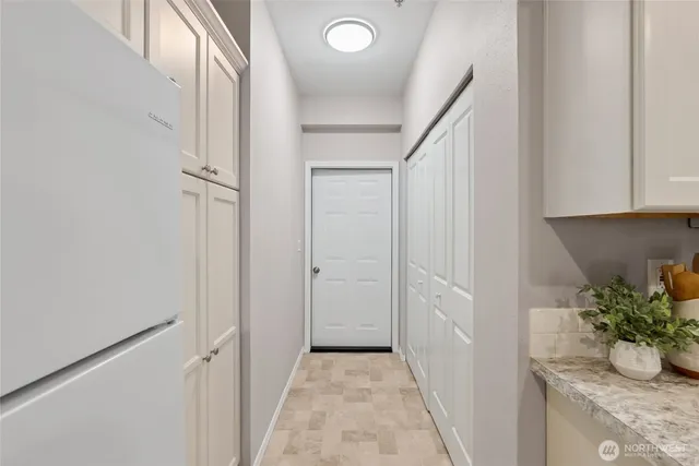 a hallway with front door and wooden floor