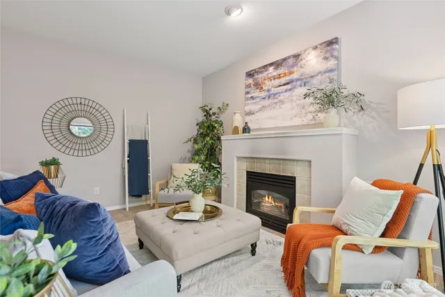 a living room with furniture potted plant and a fireplace