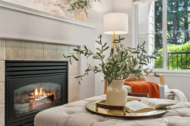 a vase of flowers sitting on a table with window
