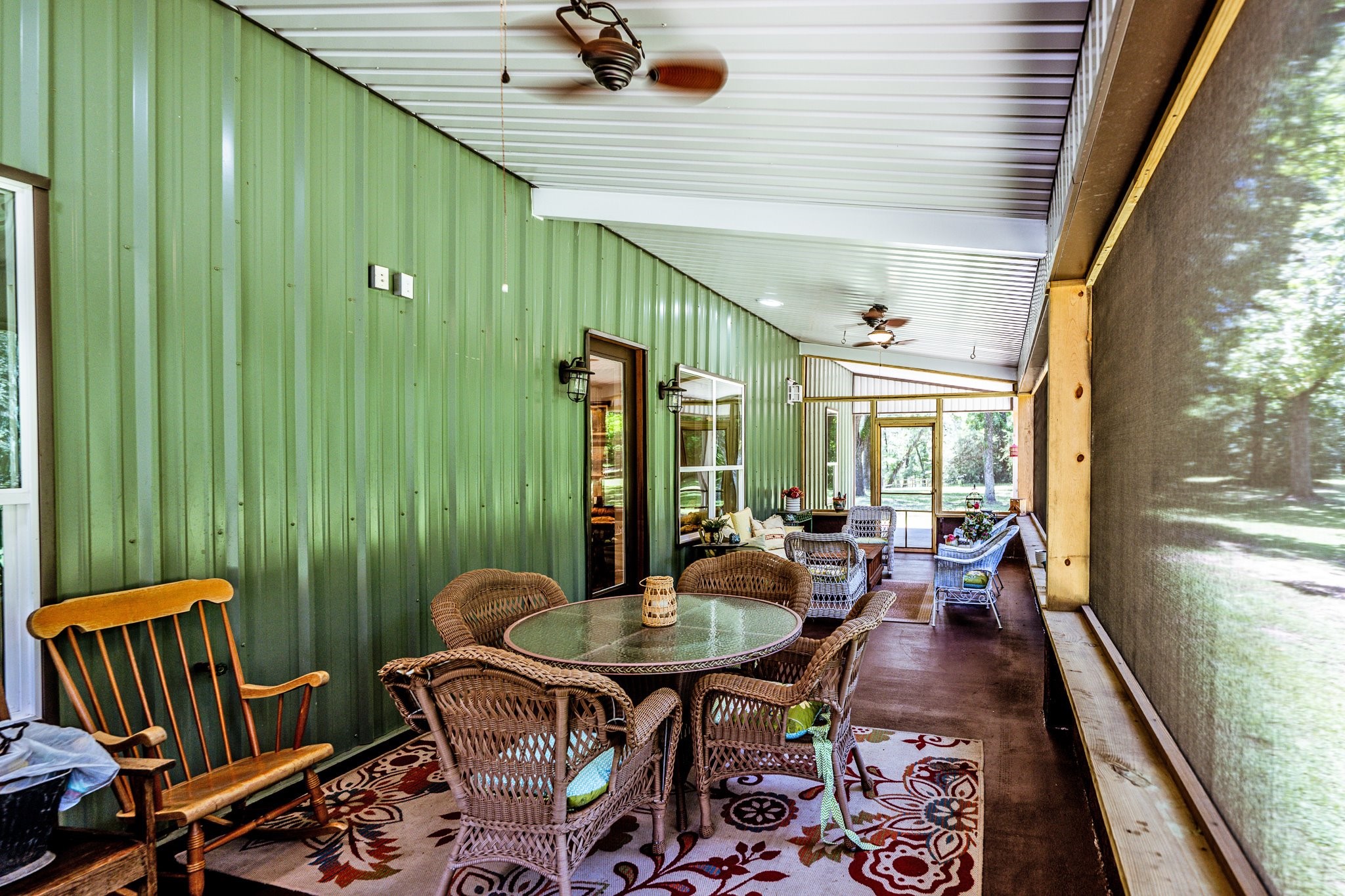13334 Fultz Road Conroe, TX 77304 - Photo 29 of 49 Screened and shaded with ceiling fans for breezy Texas evenings, this porch is built for relaxing, dining, and enjoying the outdoors in total comfort.
