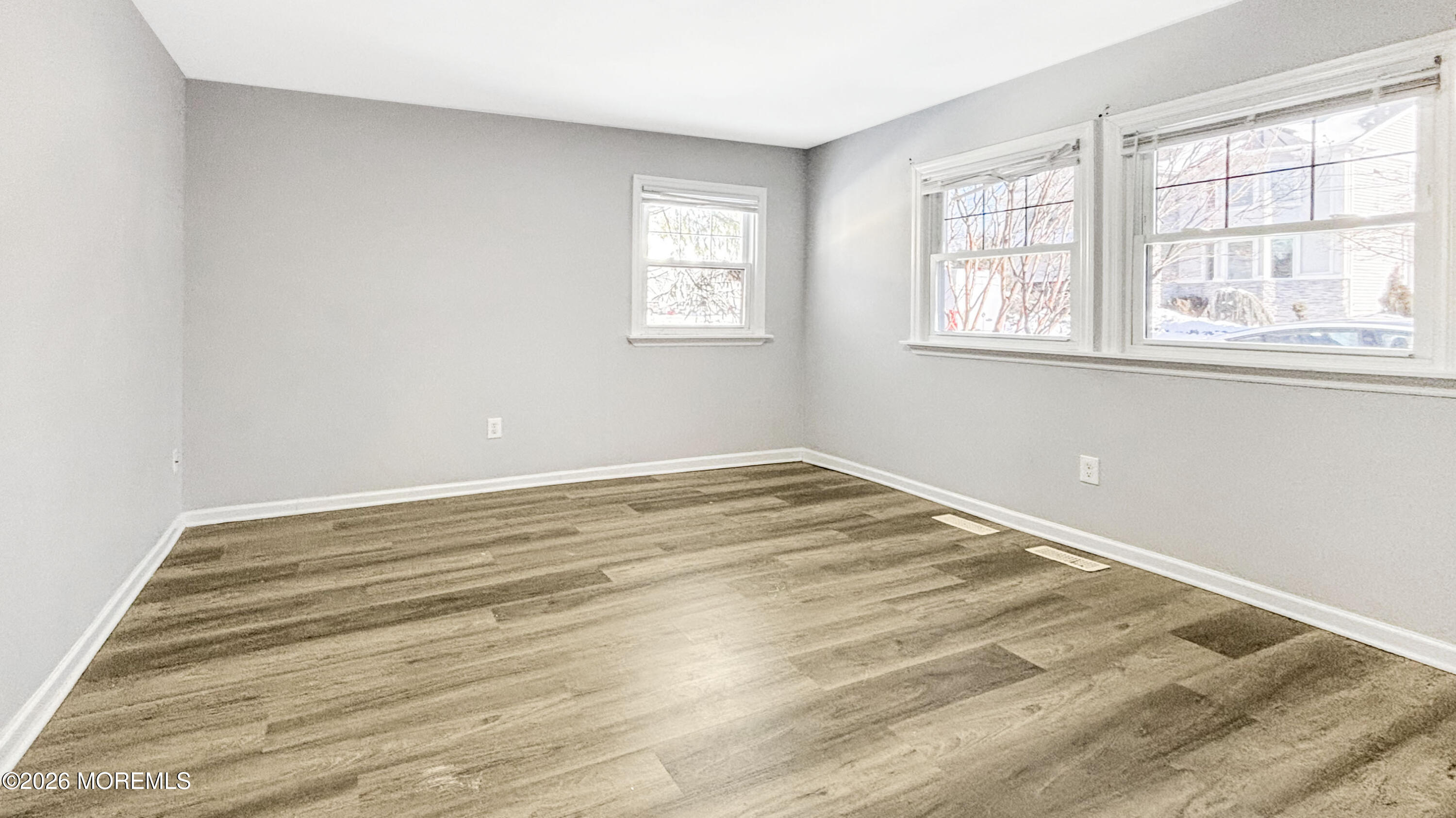 244 Overbrook Avenue Oakhurst, NJ 07755 - Photo 4 of 8 a view of a room with wooden floor and windows