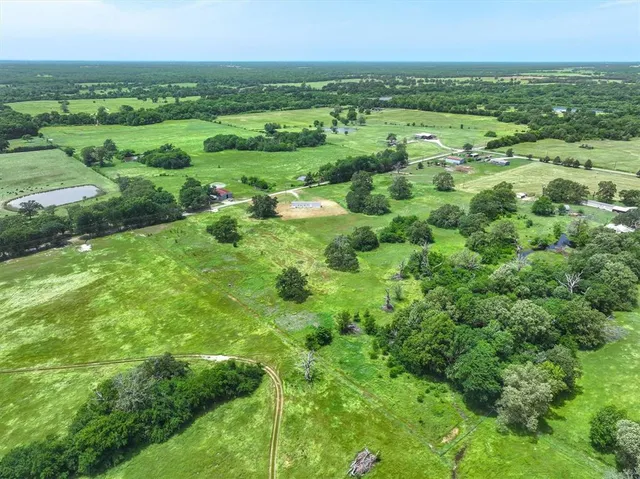 a view of a green field with lots of trees