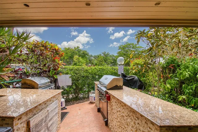 a view of a pool with a bench in the patio