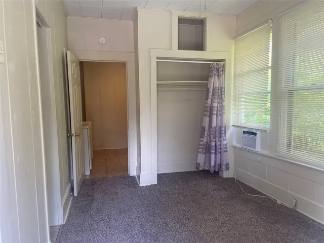 a view of an empty room with a fireplace