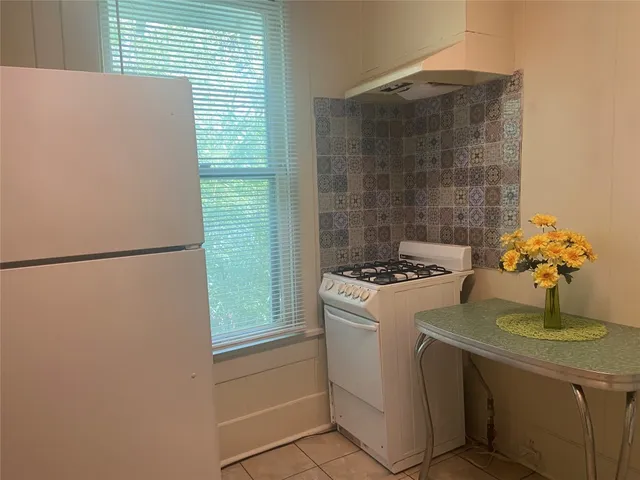a kitchen with a sink and a refrigerator