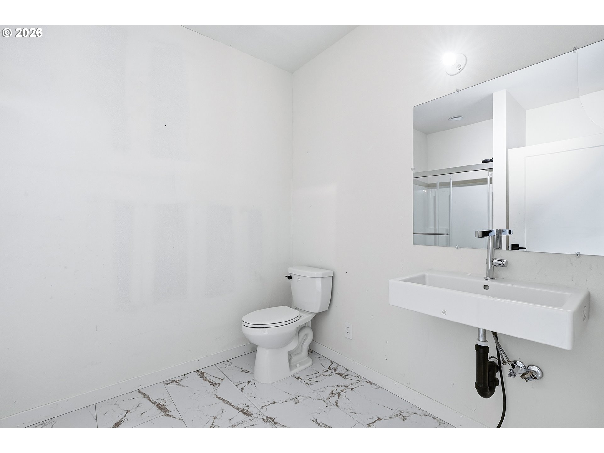 21280 Southwest Baseline Road Beaverton, OR 97003 - Photo 26 of 45 a bathroom with a sink a toilet and mirror
