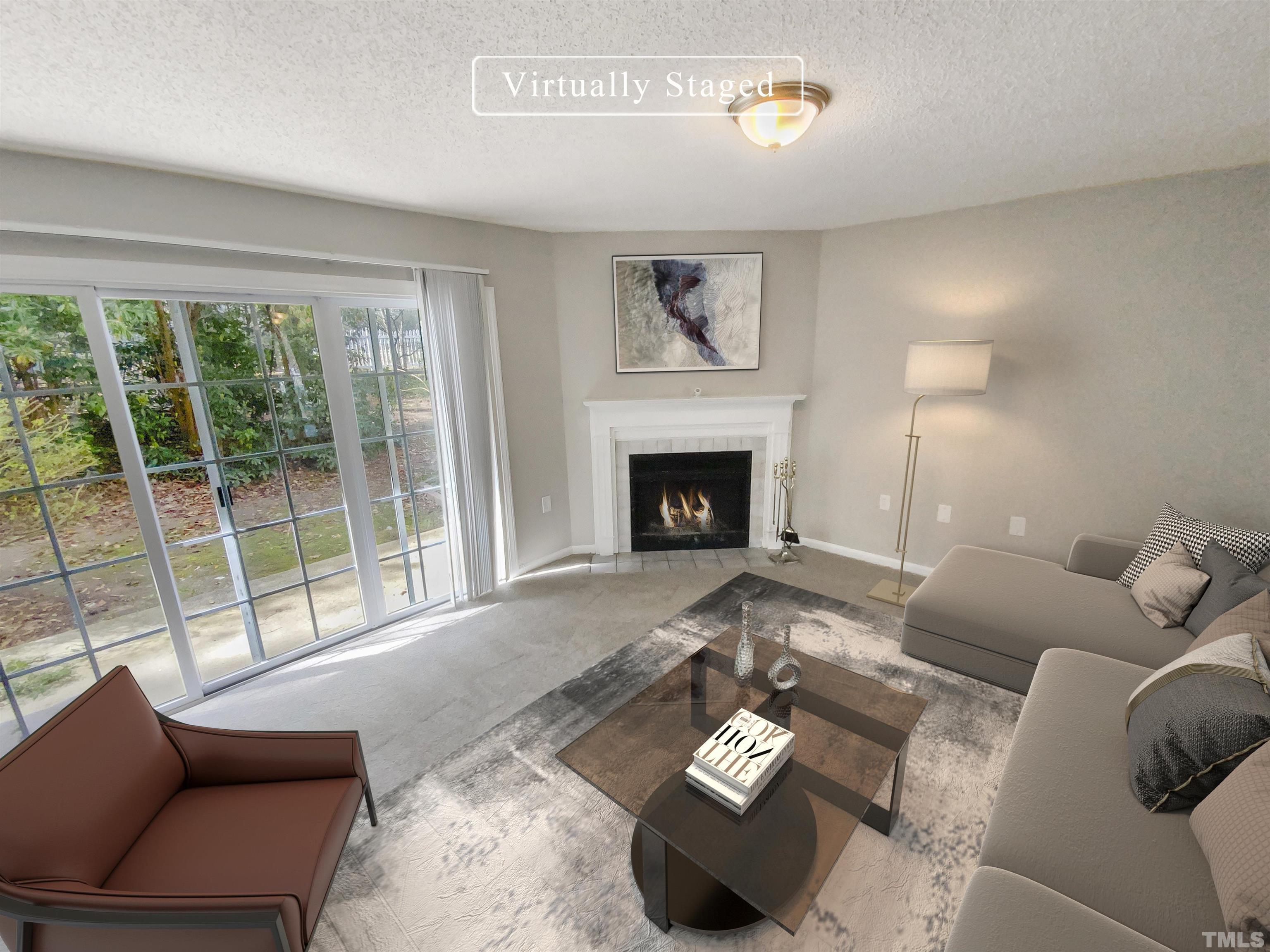 2430 Condor Court, Unit 2430 Raleigh, NC 27615 - Photo 2 of 19 a living room with furniture and a fireplace