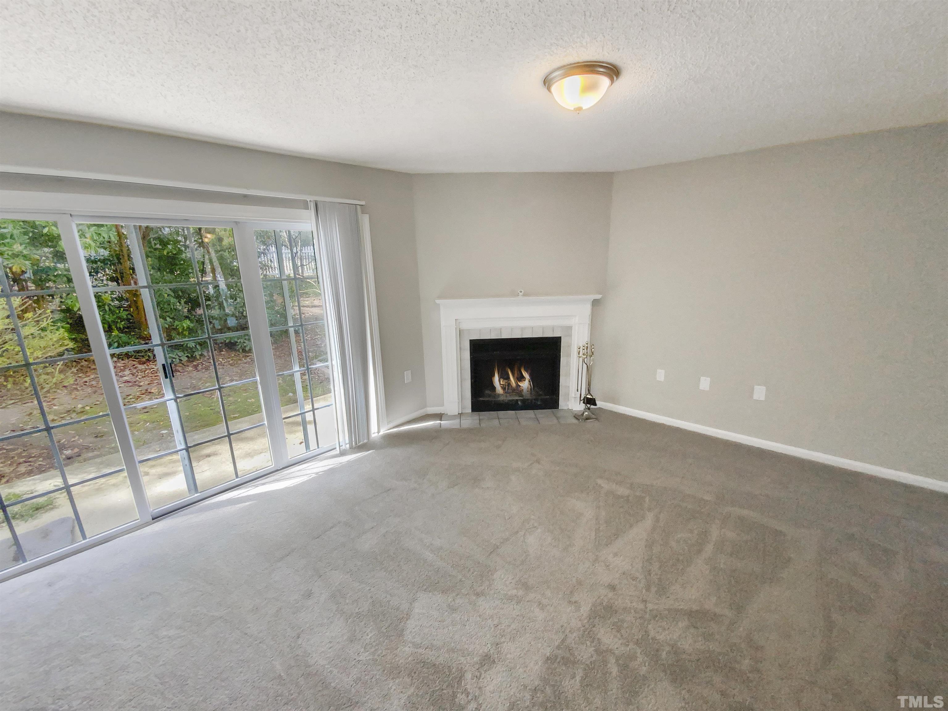 2430 Condor Court, Unit 2430 Raleigh, NC 27615 - Photo 3 of 19 a view of empty room with floor to ceiling window and an outdoor view