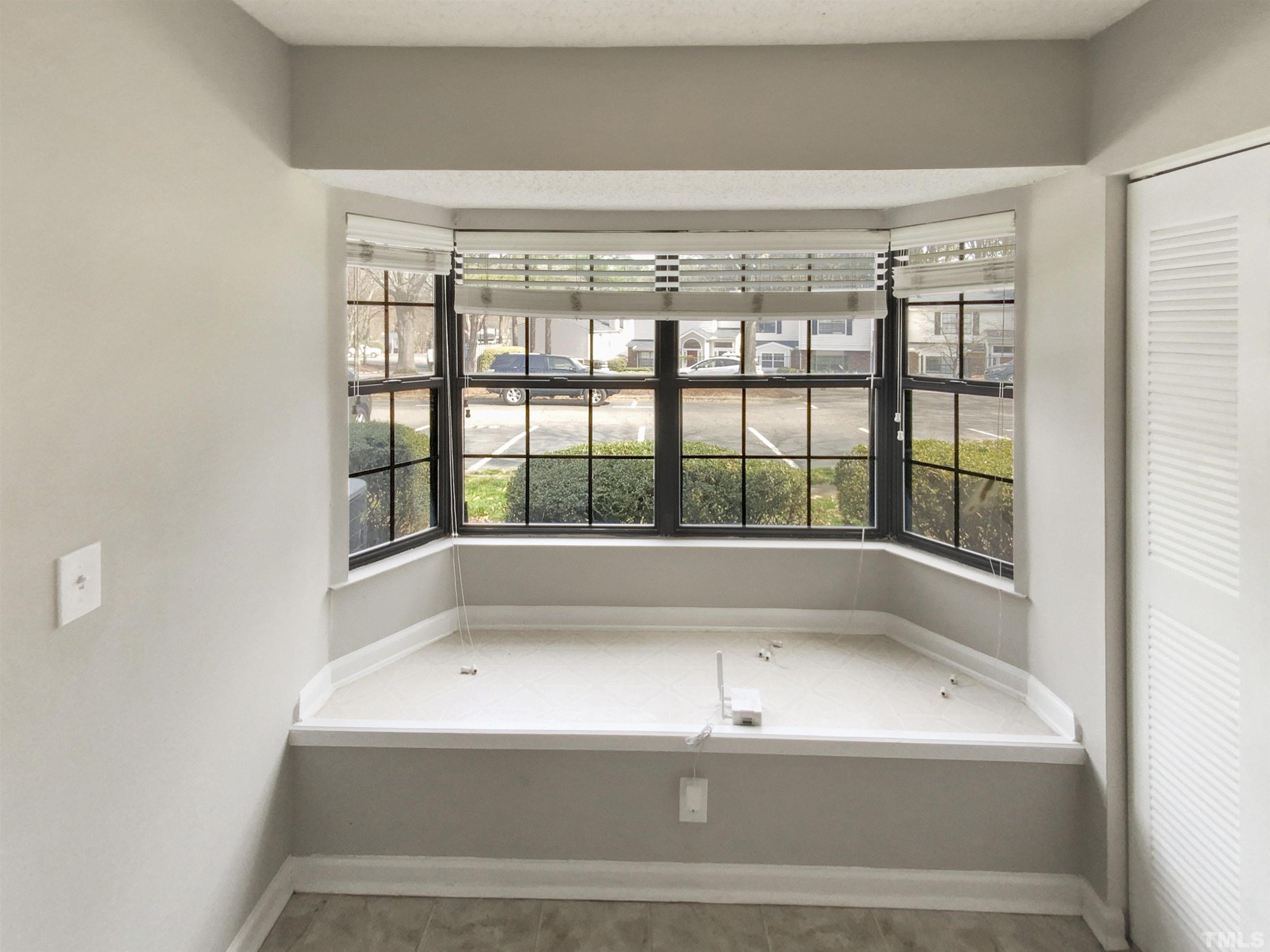 2430 Condor Court, Unit 2430 Raleigh, NC 27615 - Photo 8 of 19 a bathroom with a bathtub and window