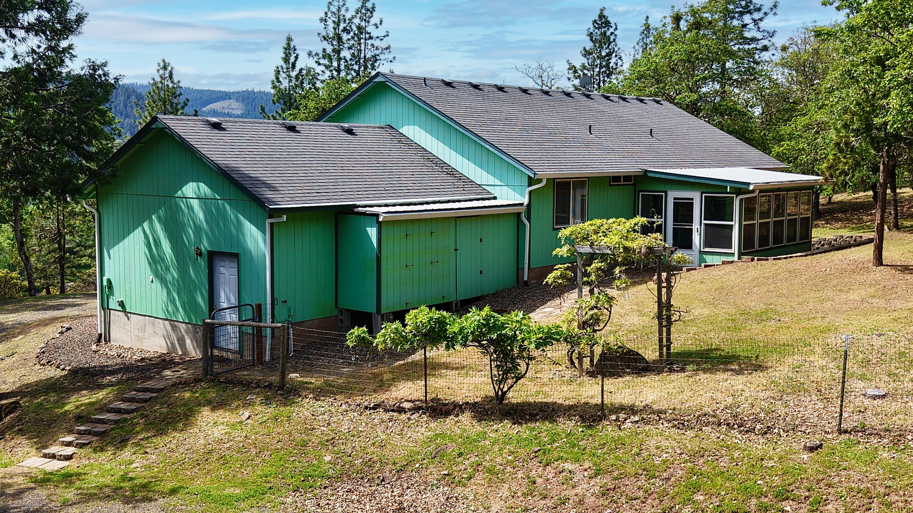204 Shipley Terrace Prospect, OR 97536 - Photo 61 of 61 a front view of a house with a yard and potted plants