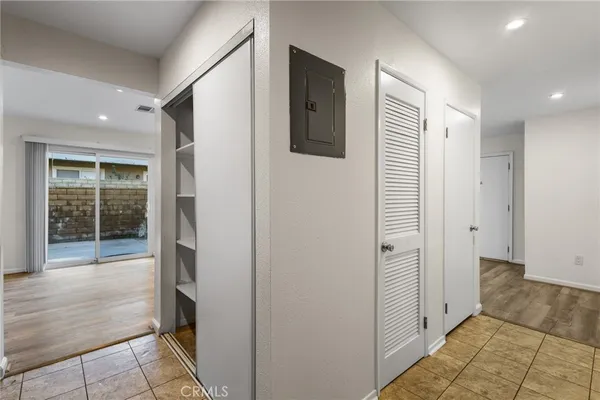 a view of a hallway with wooden shelves