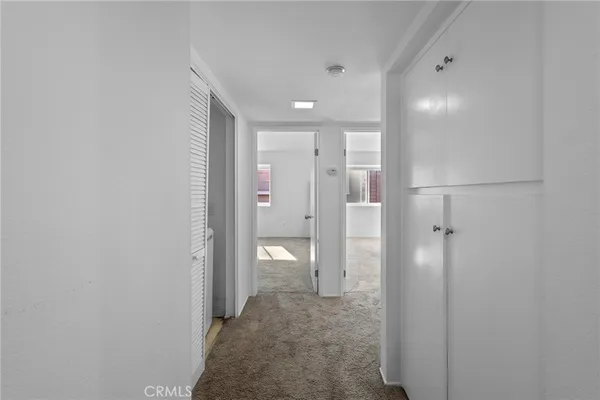 a view of a hallway with wooden shelves