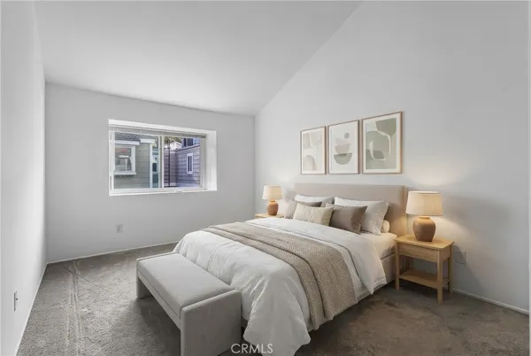 a bedroom with a bed and a painting on the wall