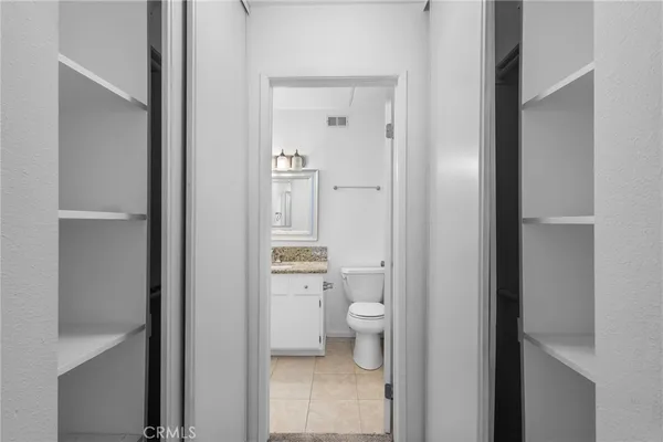 a bathroom with a granite countertop toilet