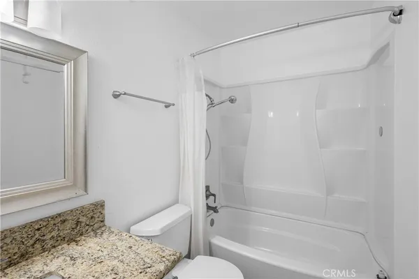 a bathroom with a shower and a bath tub