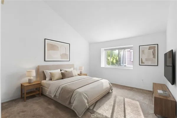 a bedroom with a bed and a tv