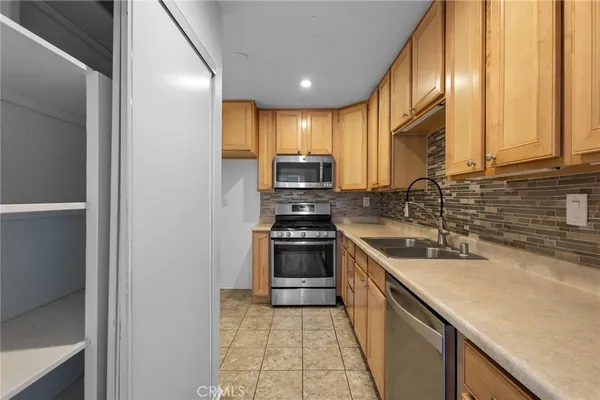 a kitchen with a sink a stove and cabinets