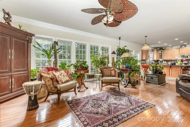 a living room with lots of furniture and a large window