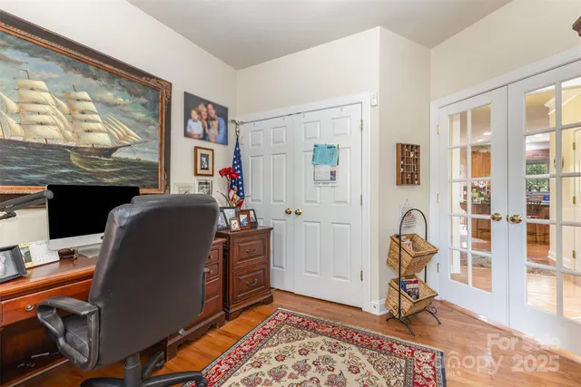 a view of a workspace with furniture and a window