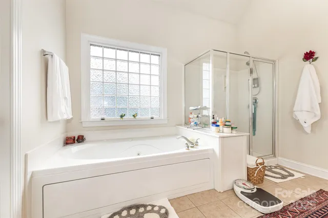 a bathroom with a tub sink and a window
